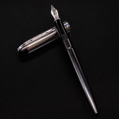 Wahl Eversharp Skyline Fountain Pen - Black & Chrome resting diagonally with the cap placed beneath it.