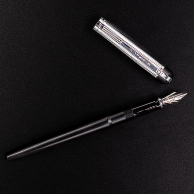 Wahl Eversharp Skyline Fountain Pen - Black & Chrome shown uncapped with cap laid beside the pen on a black background.
