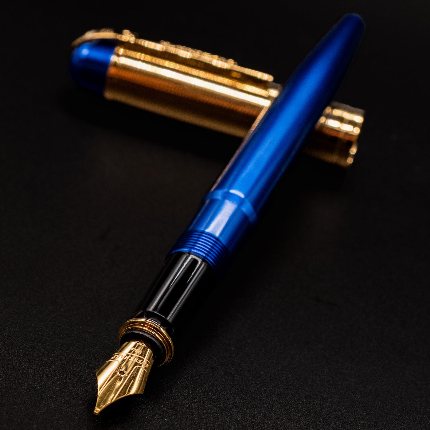 Angled shot of the Wahl Eversharp Skyline Fountain Pen - Blue & Gold with the cap behind the barrel.