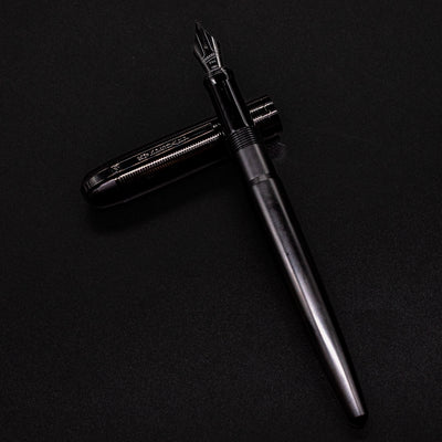Full view of the uncapped Wahl Eversharp Skyline Fountain Pen - Aviator Black laid flat with cap beside it.