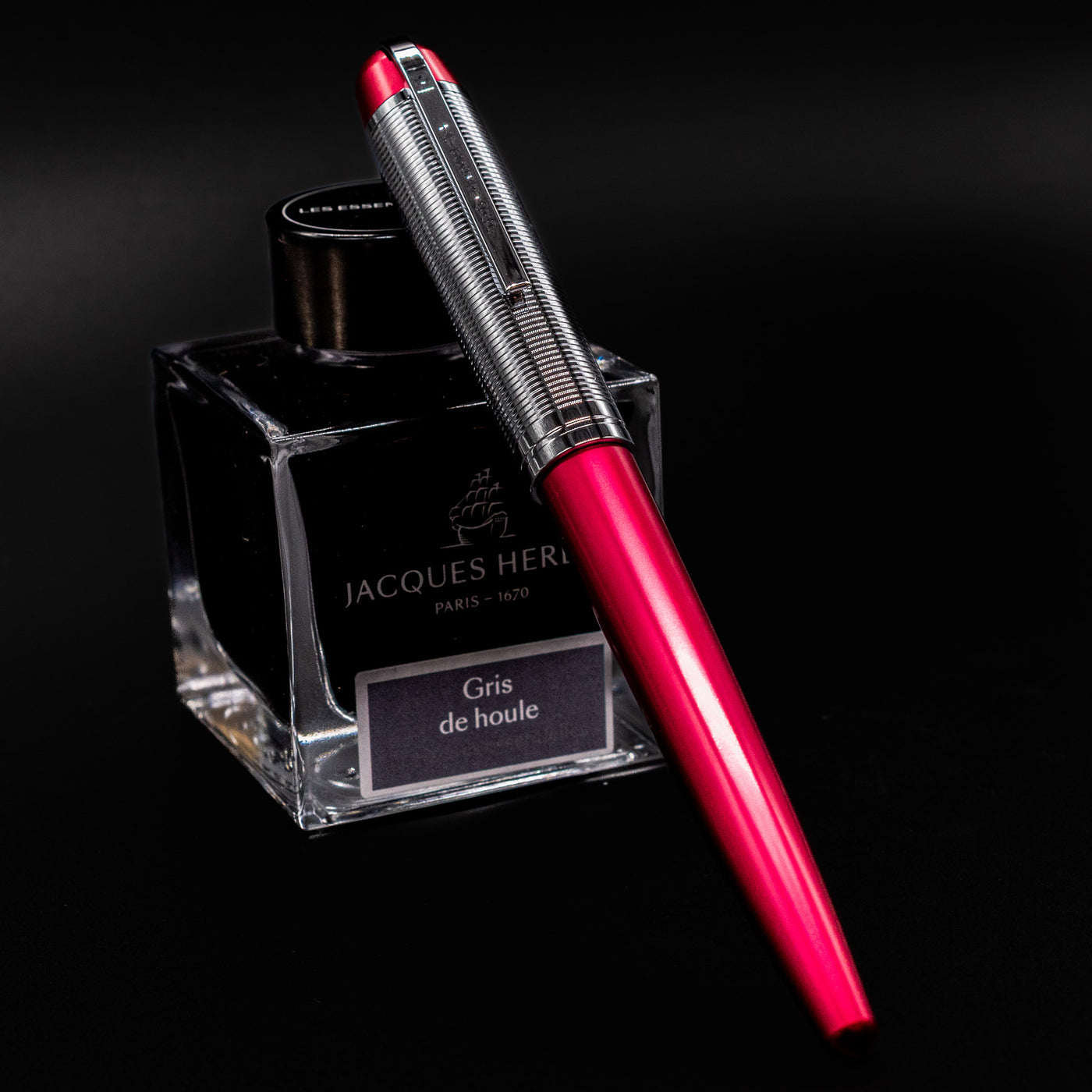 Wahl Eversharp Skyline Fountain Pen - Red & Chrome capped and resting on Jacques Herbin Gris de Houle ink bottle
