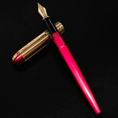 Full open view of the Wahl Eversharp Skyline Fountain Pen in Red & Gold with cap placed beside.