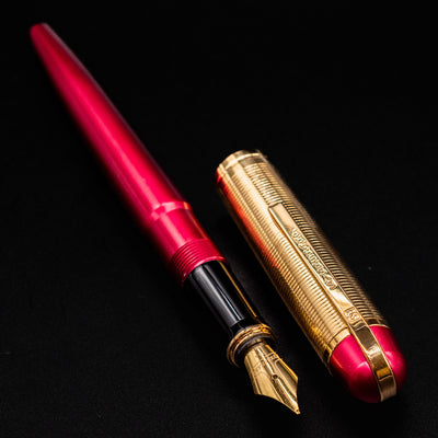 Side view of the uncapped Wahl Eversharp Skyline Fountain Pen - Red & Gold showing barrel and cap design.